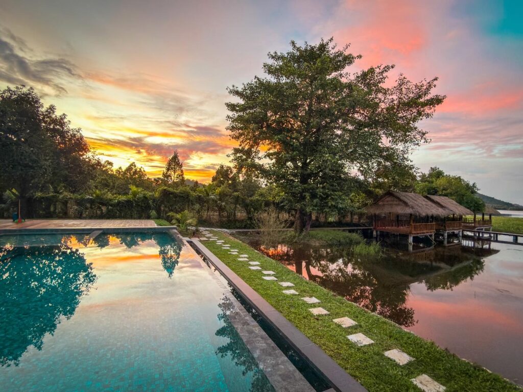 Sunset at family-friendly swimming pool by the lake